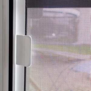 Modern aluminum screen door on a coastal home