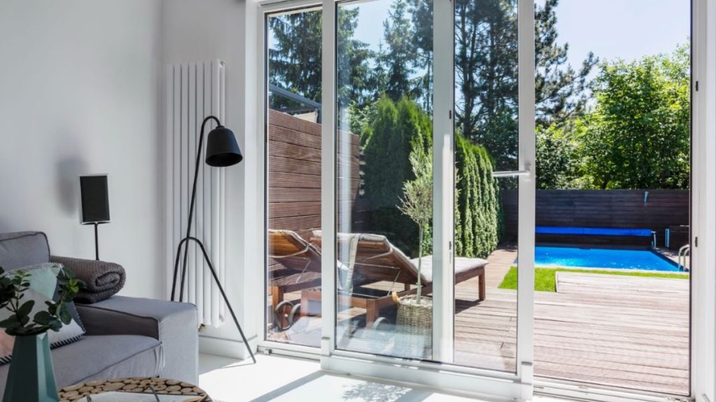 Lamp next to patio doors leading to an outdoor deck or backyard