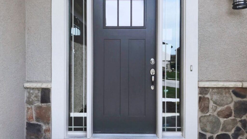 A black fiberglass entry door featuring a stylish glass panel, enhancing the home's exterior with a contemporary design.