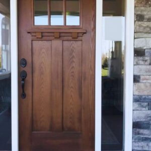 A functional and attractive fiberglass entry door featuring a wooden frame and glass panel.