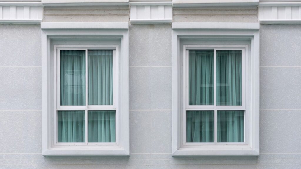 A modern white residential building showcasing multiple casement windows, demonstrating their elegant integration into contemporary architecture.