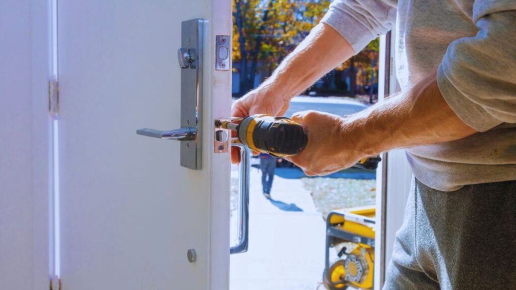 A man installs a door using a drill, demonstrating key steps in the installation process.