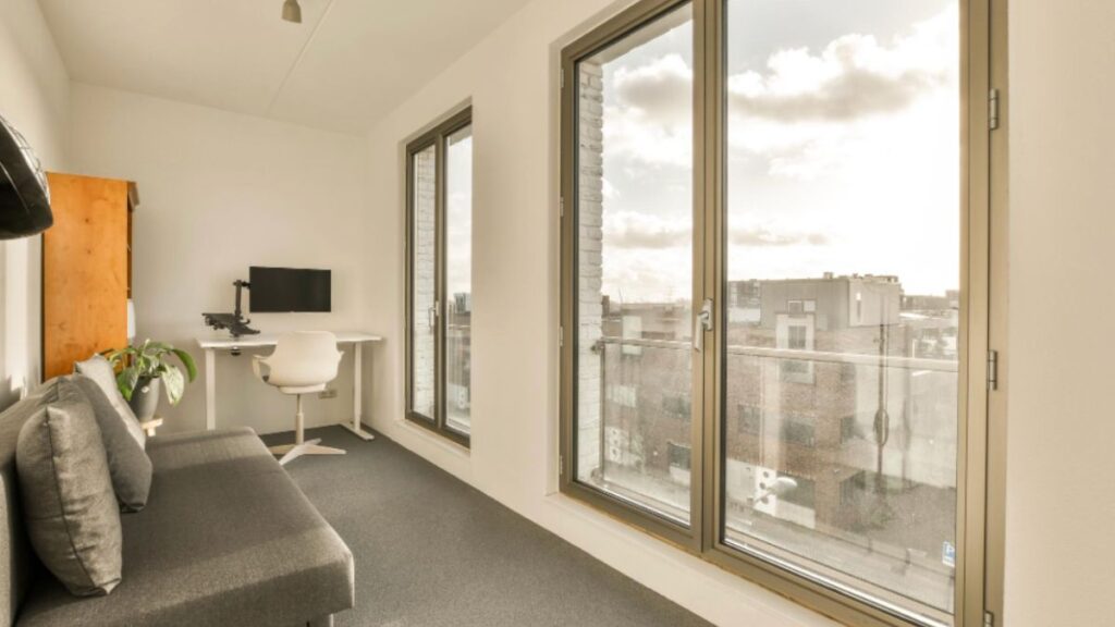 A bright room with a desk and a window revealing a cityscape, showcasing the quality of HHI Windows and Doors in Hilton Head.